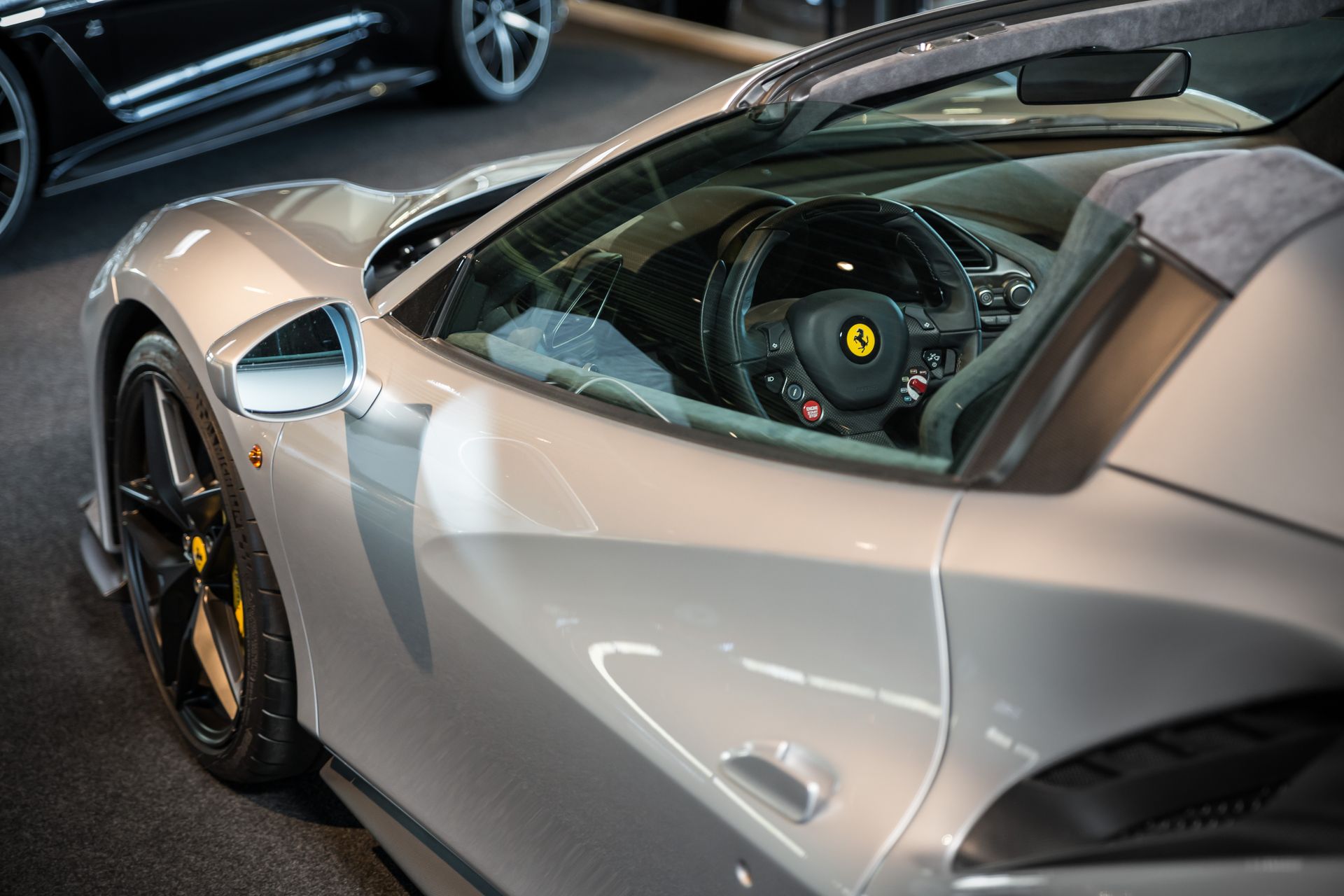 Luxe studiofoto van een zilveren Ferrari 488 Pista Spider met professionele belichting.