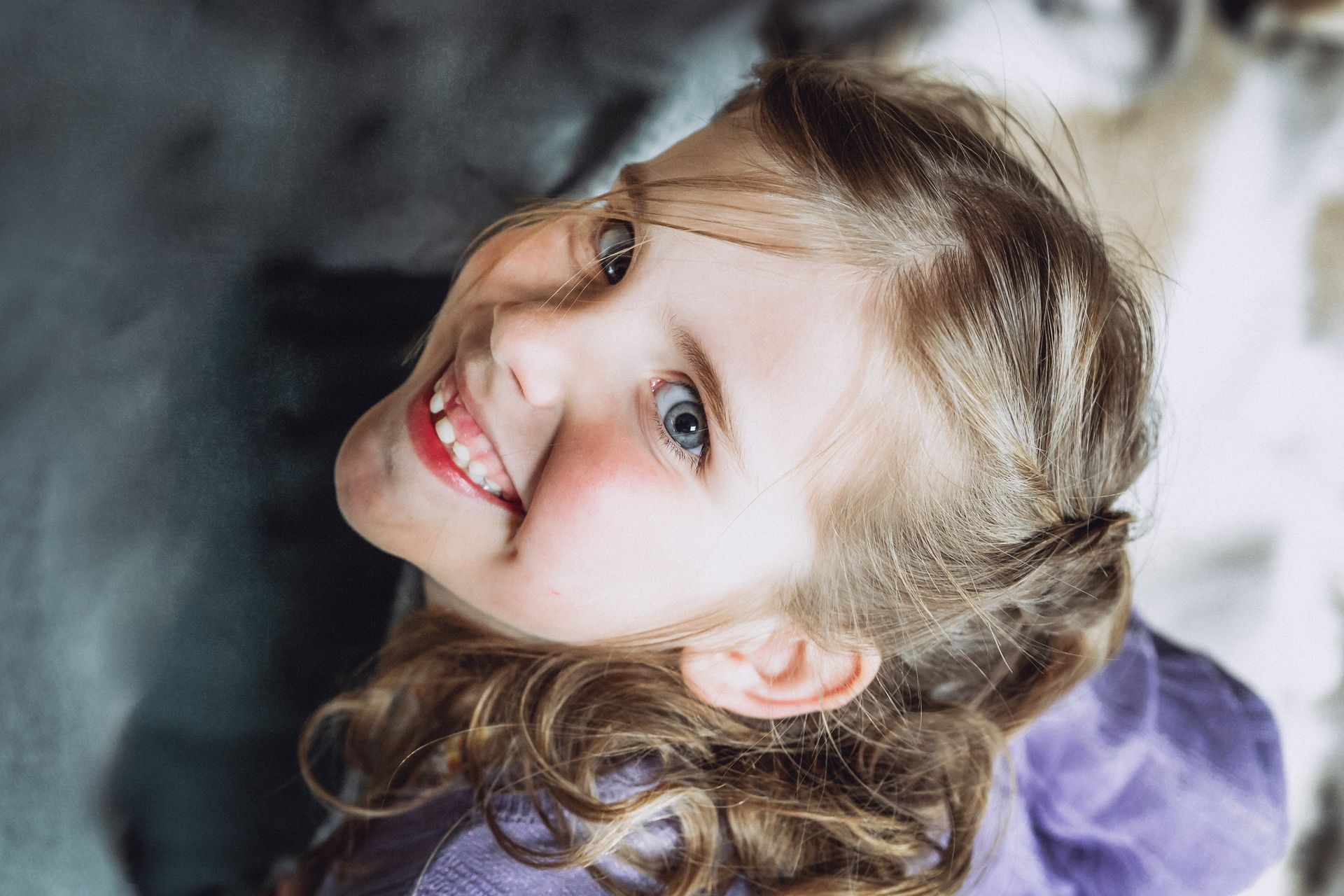 Speels poseerend kind in een lichte, oude fabriekshal.