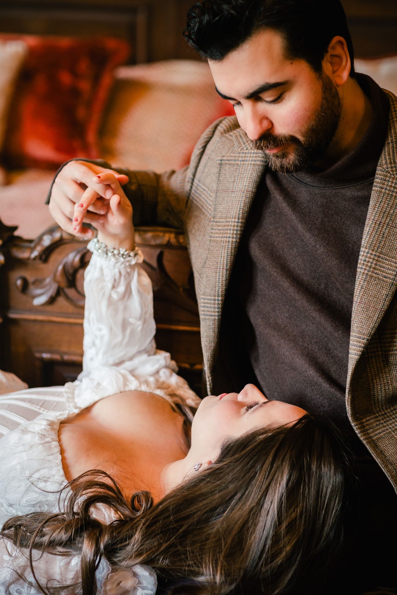 American couple sharing a loving glance during a castle photoshoot in Belgium.